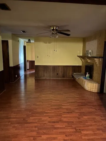 a view of kitchen and hall with wooden floor