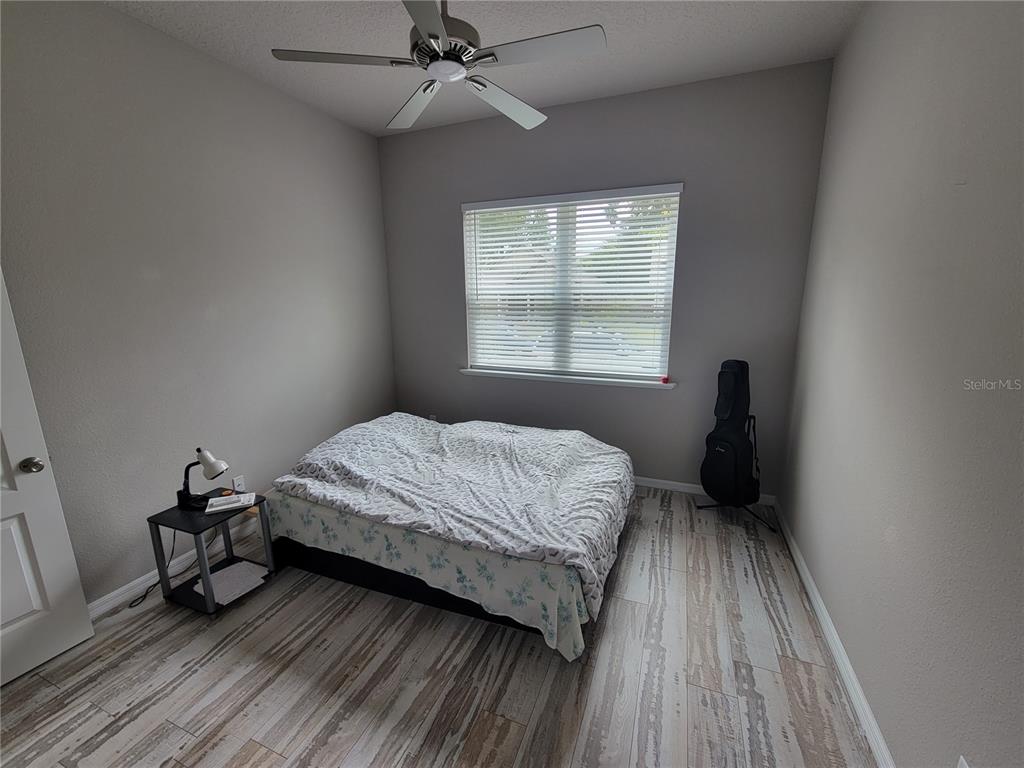 6323 Southwest 47th Terrace Gainesville, FL 32608 - Photo 11 of 25 a bedroom with a bed and a window