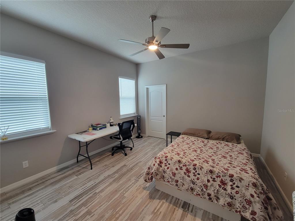 6323 Southwest 47th Terrace Gainesville, FL 32608 - Photo 13 of 25 a bedroom with a bed and a chandelier