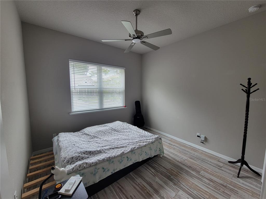 6323 Southwest 47th Terrace Gainesville, FL 32608 - Photo 19 of 25 a bedroom with a bed and a window