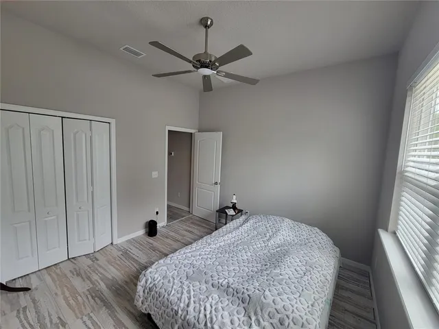 a bedroom with a bed and a window