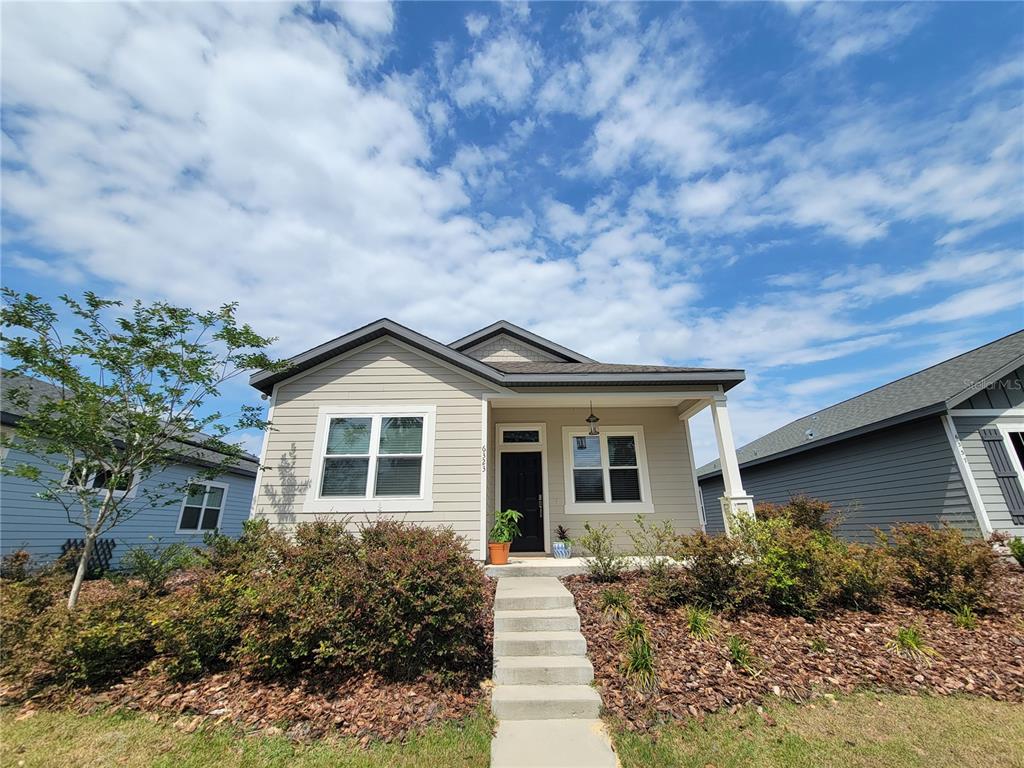 6323 Southwest 47th Terrace Gainesville, FL 32608 - Photo 25 of 25 a front view of a house with garden