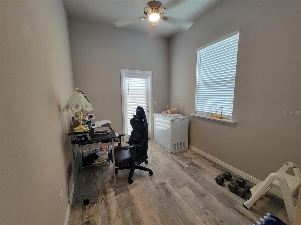 6323 Southwest 47th Terrace Gainesville, FL 32608 - Photo 10 of 25 a workspace with wooden floor and a window