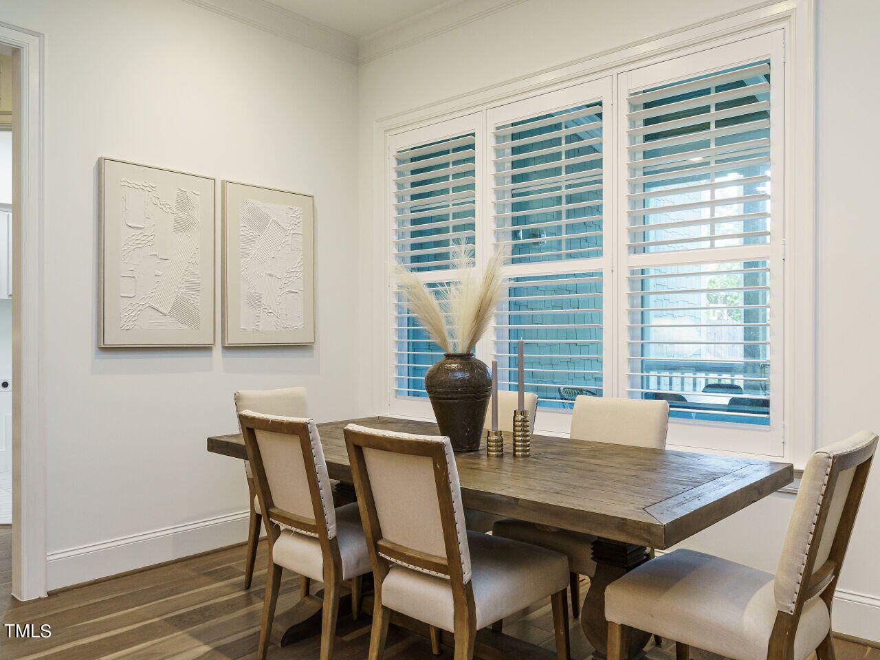 4405 Boxwood Road Raleigh, NC 27612 - Photo 13 of 58 a view of a dining room with furniture and wooden floor