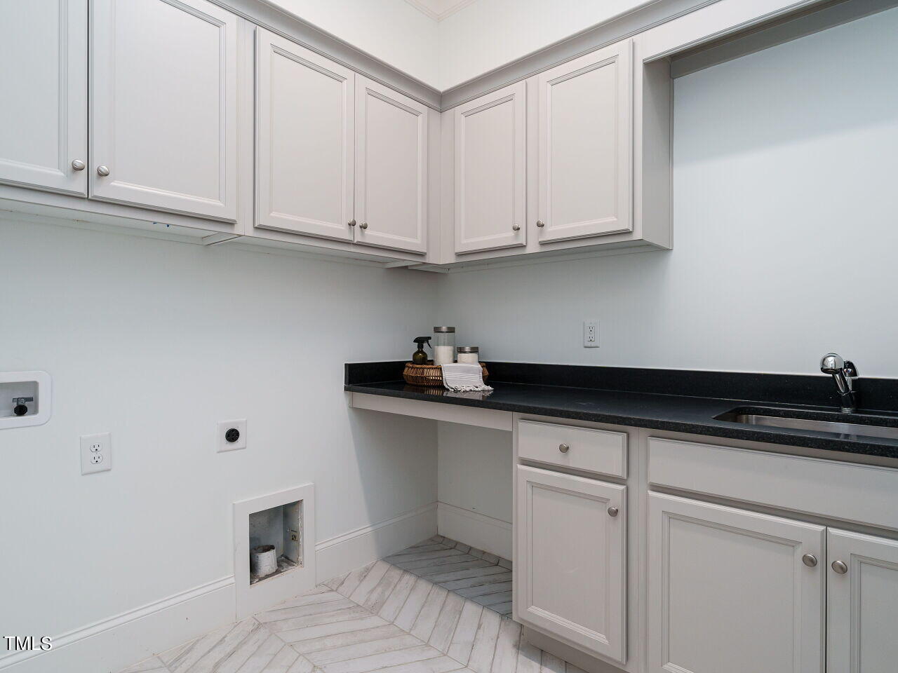 4405 Boxwood Road Raleigh, NC 27612 - Photo 21 of 58 a kitchen with white cabinets and sink