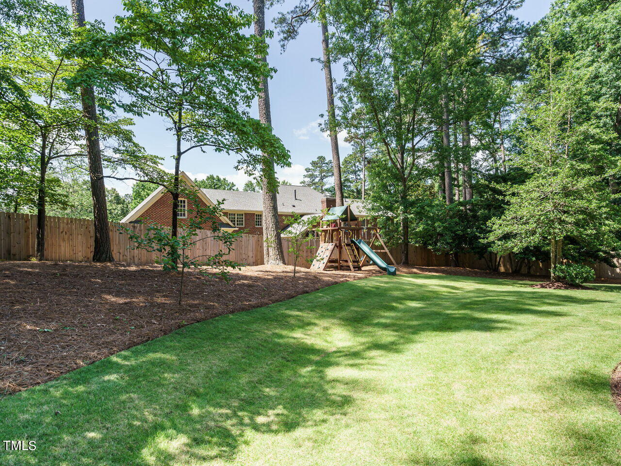 4405 Boxwood Road Raleigh, NC 27612 - Photo 43 of 58 a view of a backyard with a slide