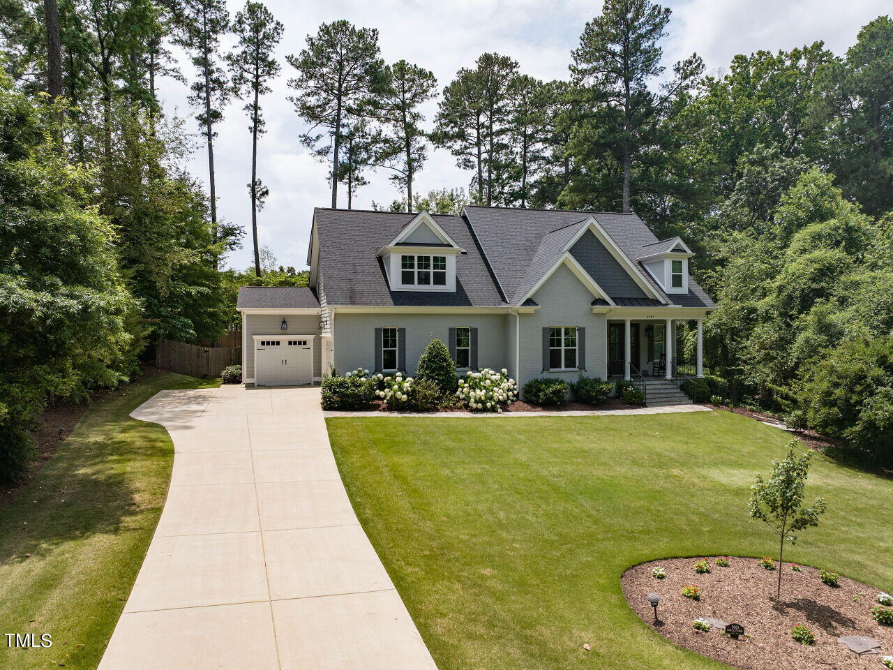 4405 Boxwood Road Raleigh, NC 27612 - Photo 46 of 58 a front view of a house with a garden
