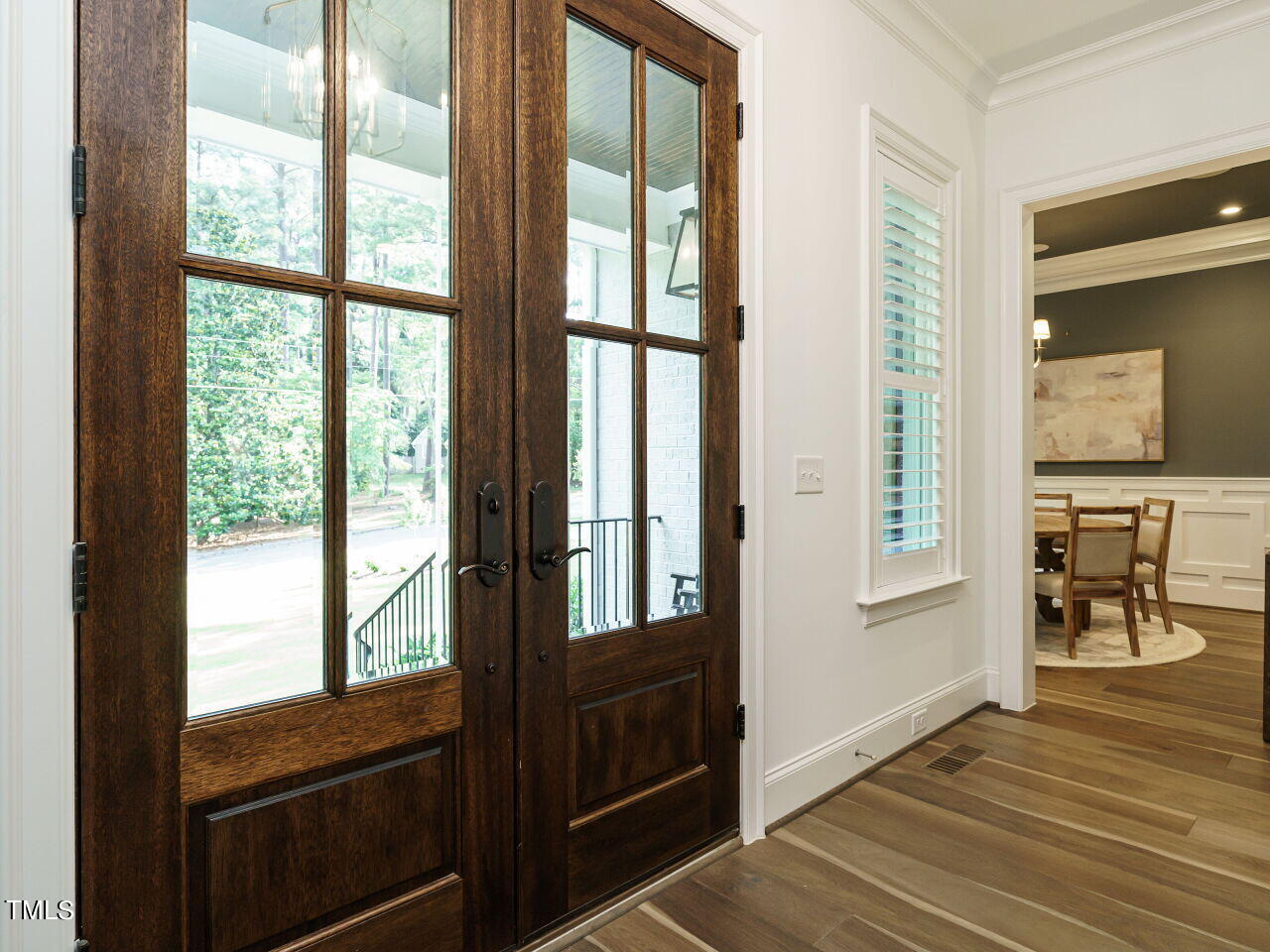 4405 Boxwood Road Raleigh, NC 27612 - Photo 5 of 58 a view of a hallway with wooden floor and windows
