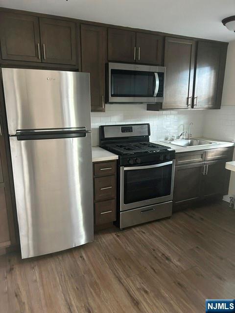 415 Ridge Road, Unit E North Arlington, NJ 07031 - Photo 4 of 6 a kitchen with stainless steel appliances a refrigerator a stove top oven a sink and dishwasher