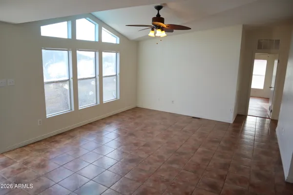 a view of a kitchen with a sink and dishwasher with wooden floor