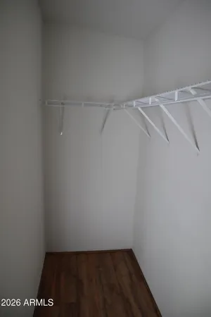 a room with a wooden floor and brick wall