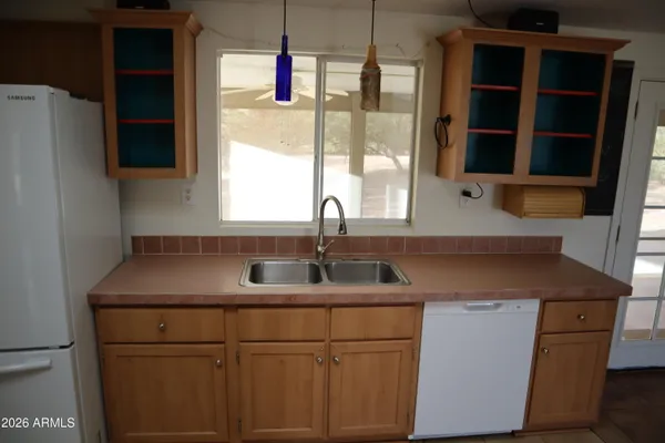 a kitchen with cabinets appliances and a sink
