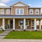 front view of a brick house with a yard
