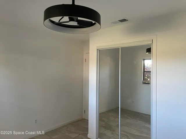 a view of an empty room with a bathroom