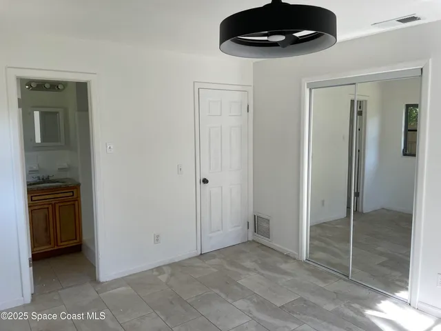 a bathroom with a granite countertop toilet and a sink