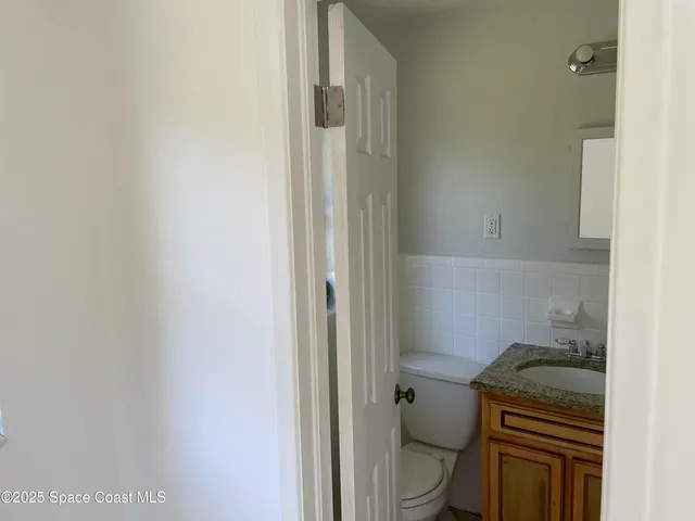 a view of an empty room with a bathroom