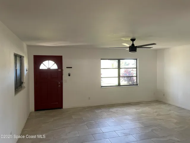 an empty room with windows and closet