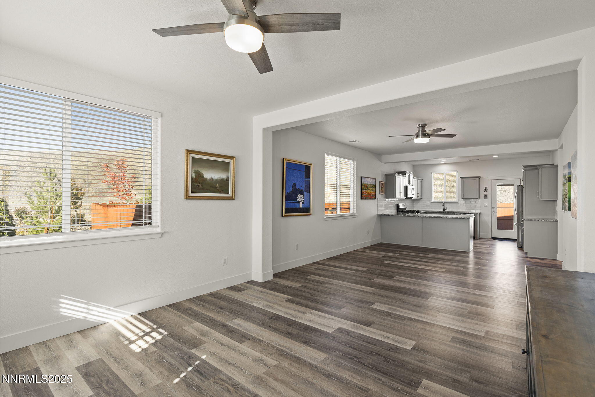 1075 West Slab Cliffs Reno, NV 89508 - Photo 4 of 22 a view of a livingroom with wooden floor and a kitchen