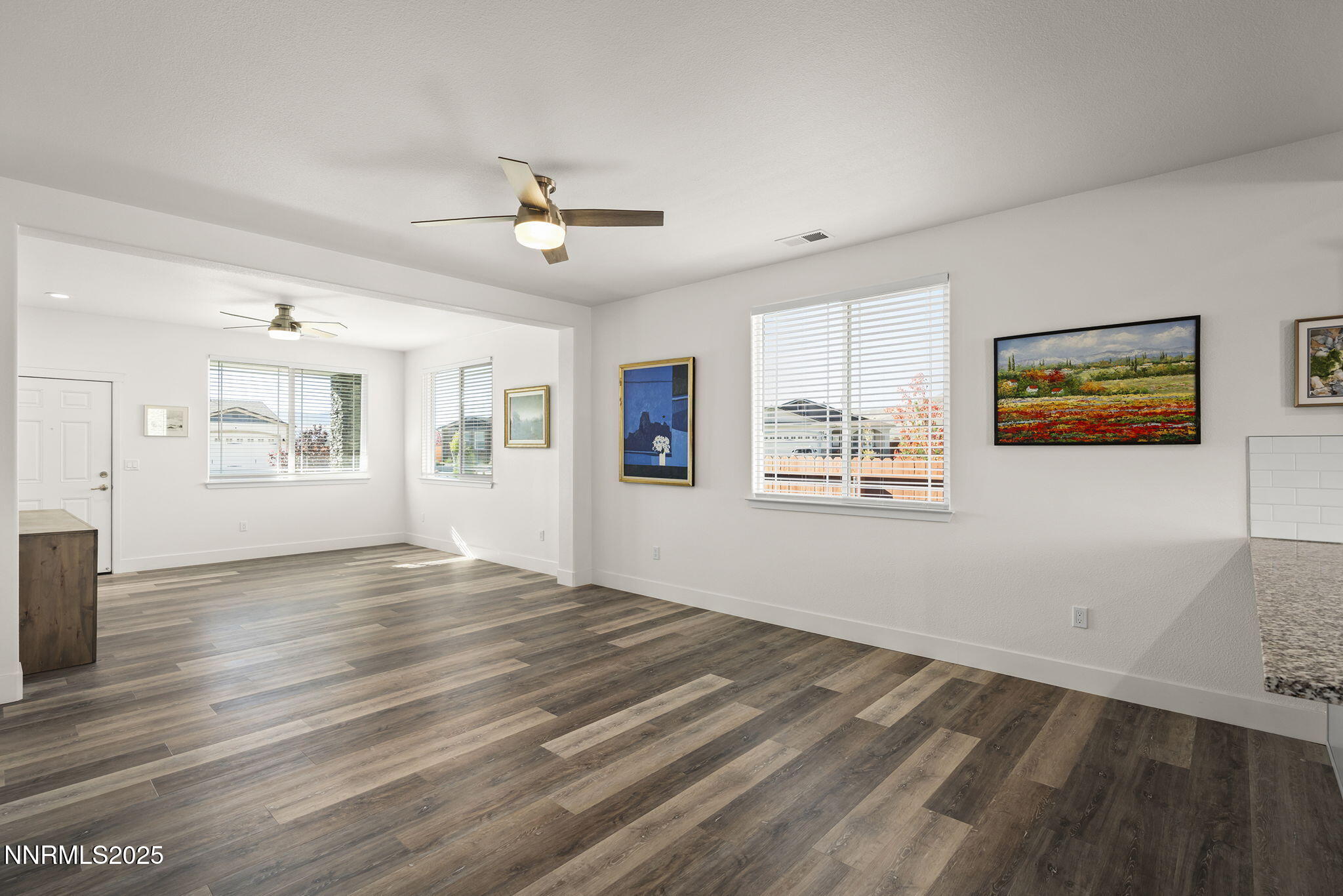 1075 West Slab Cliffs Reno, NV 89508 - Photo 6 of 22 a view of an empty room with window and wooden floor