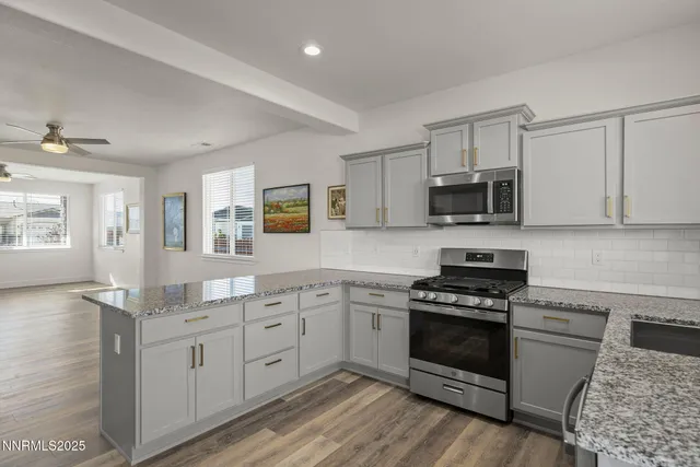 a kitchen with white cabinets and appliances