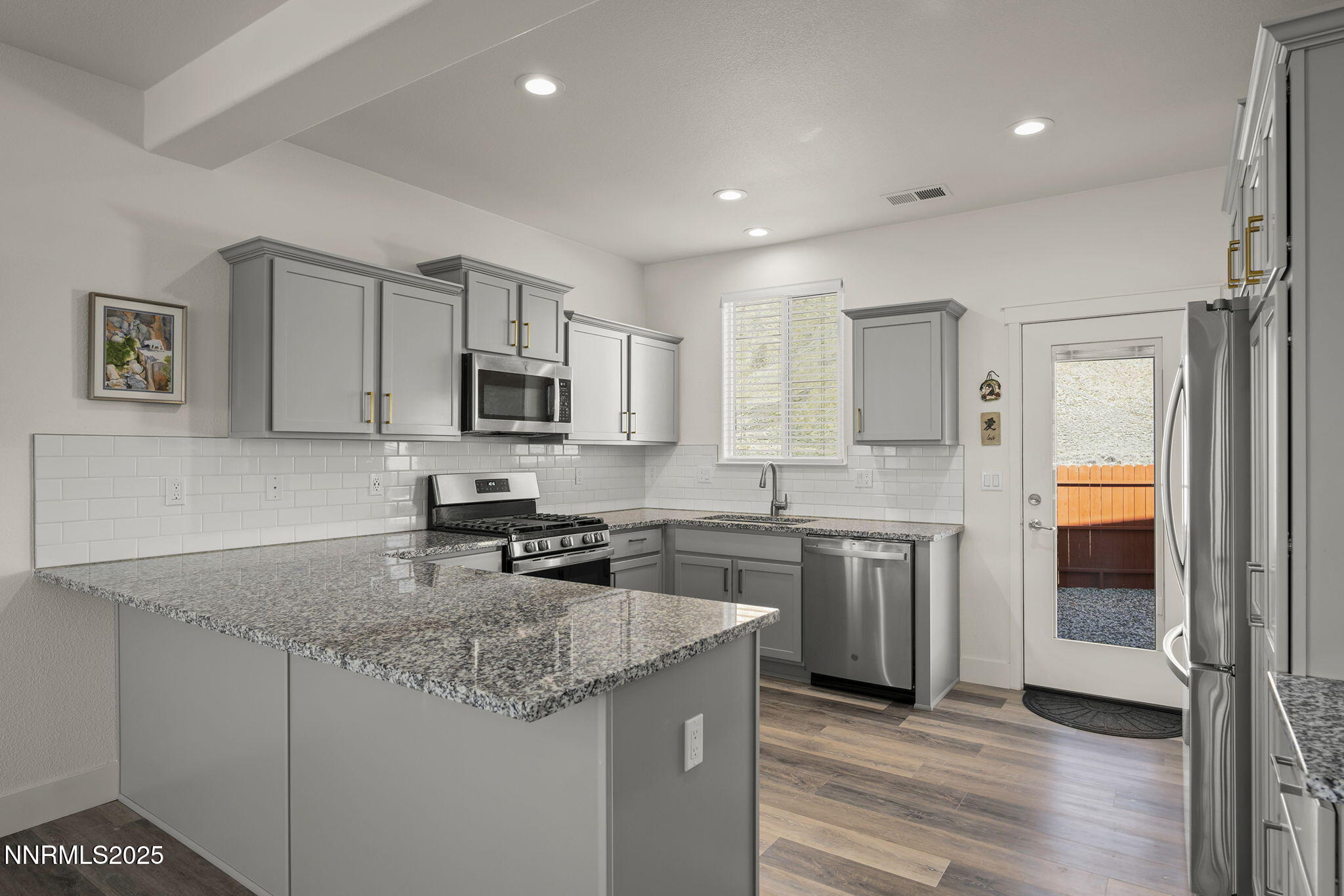 1075 West Slab Cliffs Reno, NV 89508 - Photo 9 of 22 a kitchen with stainless steel appliances granite countertop a sink stove and refrigerator