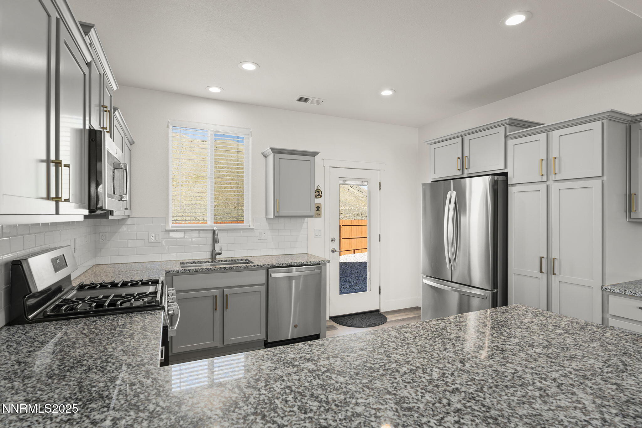 1075 West Slab Cliffs Reno, NV 89508 - Photo 10 of 22 a kitchen with stainless steel appliances granite countertop a refrigerator and a sink