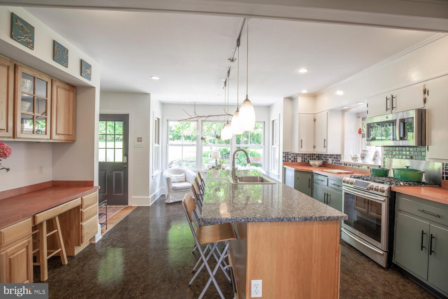 4367 Curly Hill Road Doylestown, PA 18902 - Photo 12 of 72 a kitchen with stainless steel appliances granite countertop a stove top oven a sink dishwasher a dining table and chairs with wooden floor