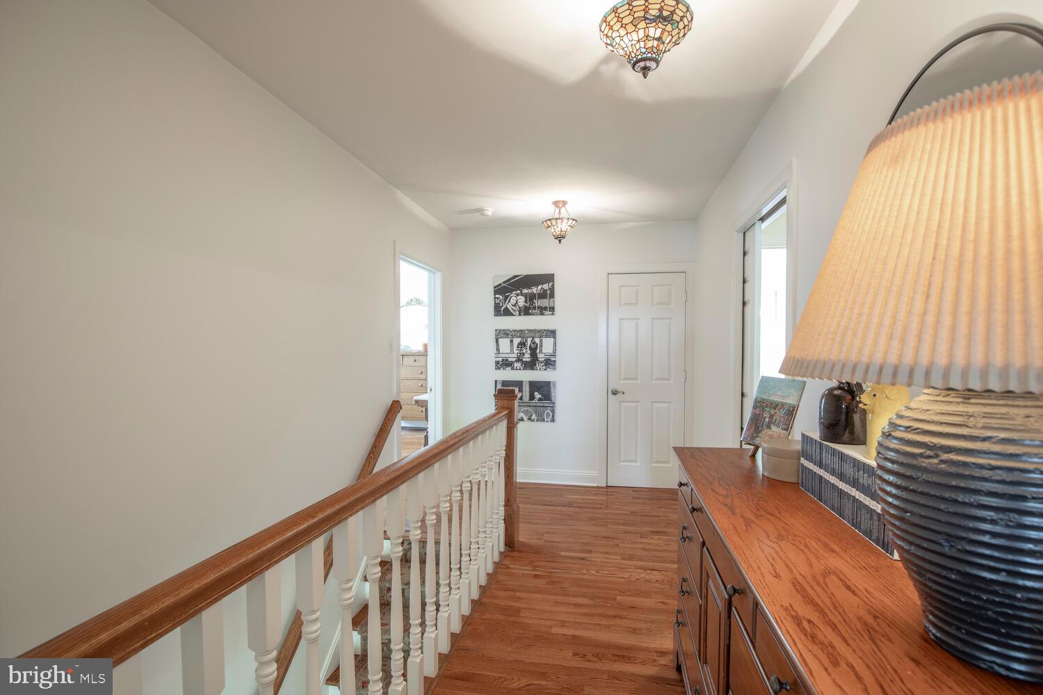 4367 Curly Hill Road Doylestown, PA 18902 - Photo 35 of 72 a view of a hallway with a window and wooden floor