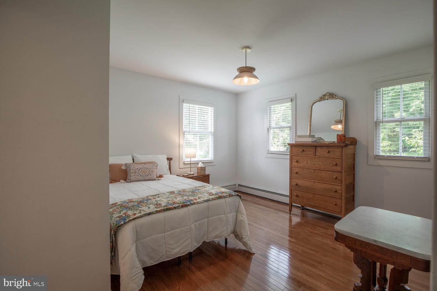 4367 Curly Hill Road Doylestown, PA 18902 - Photo 45 of 72 a bedroom with a bed and a dresser next to a window