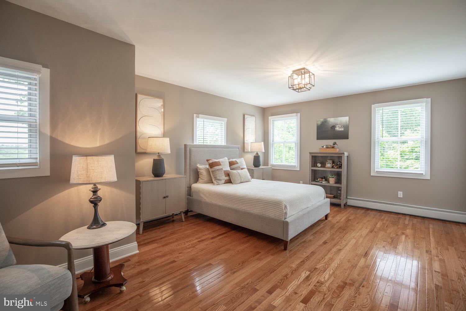 4367 Curly Hill Road Doylestown, PA 18902 - Photo 49 of 72 a spacious bedroom with a bed and wooden floor