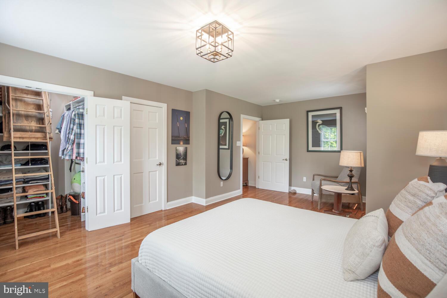 4367 Curly Hill Road Doylestown, PA 18902 - Photo 50 of 72 a bedroom with a large bed and a chandelier