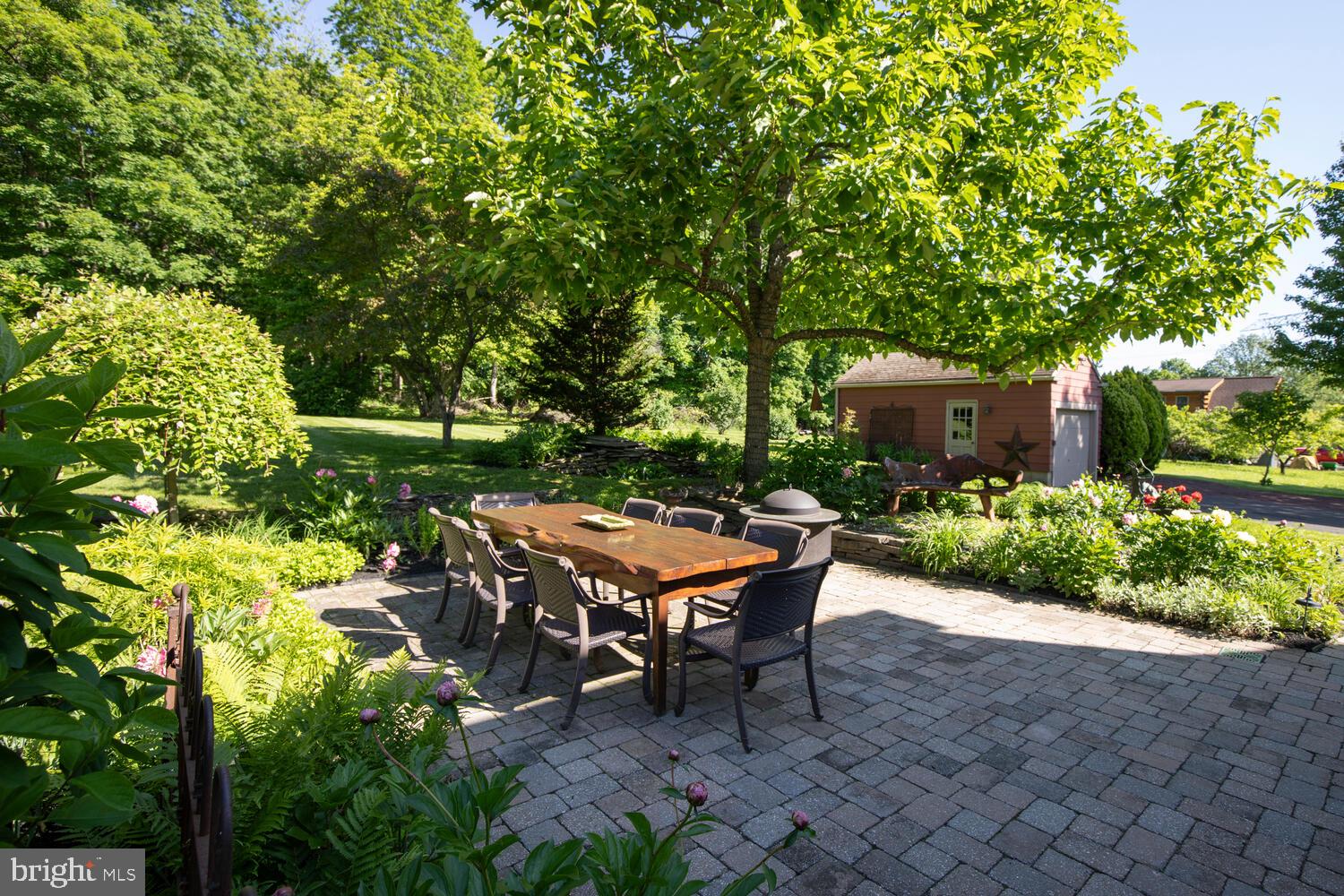 4367 Curly Hill Road Doylestown, PA 18902 - Photo 55 of 72 a wooden bench sitting in the middle of a garden