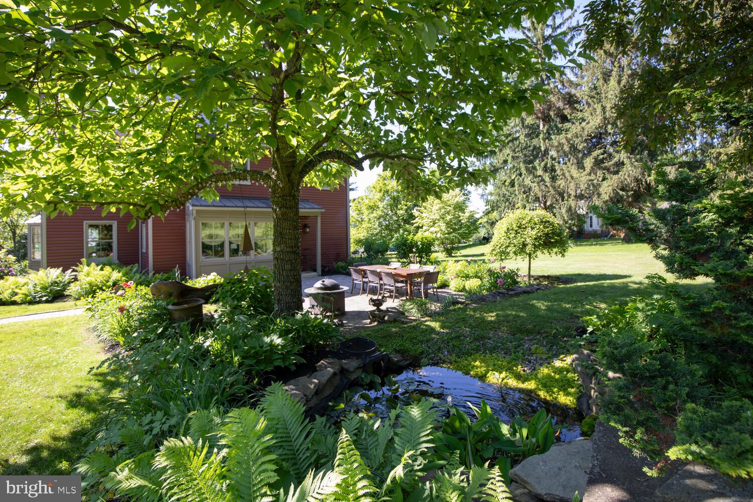 4367 Curly Hill Road Doylestown, PA 18902 - Photo 56 of 72 a backyard of a house with a garden and outdoor seating