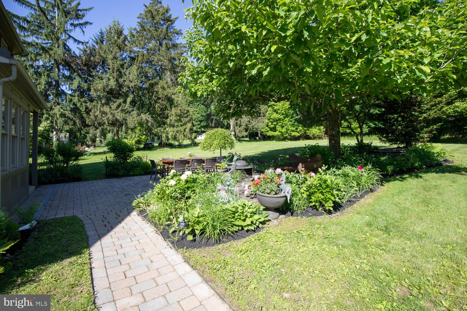 4367 Curly Hill Road Doylestown, PA 18902 - Photo 57 of 72 a view of a garden with a lot of flower plants and wooden fence