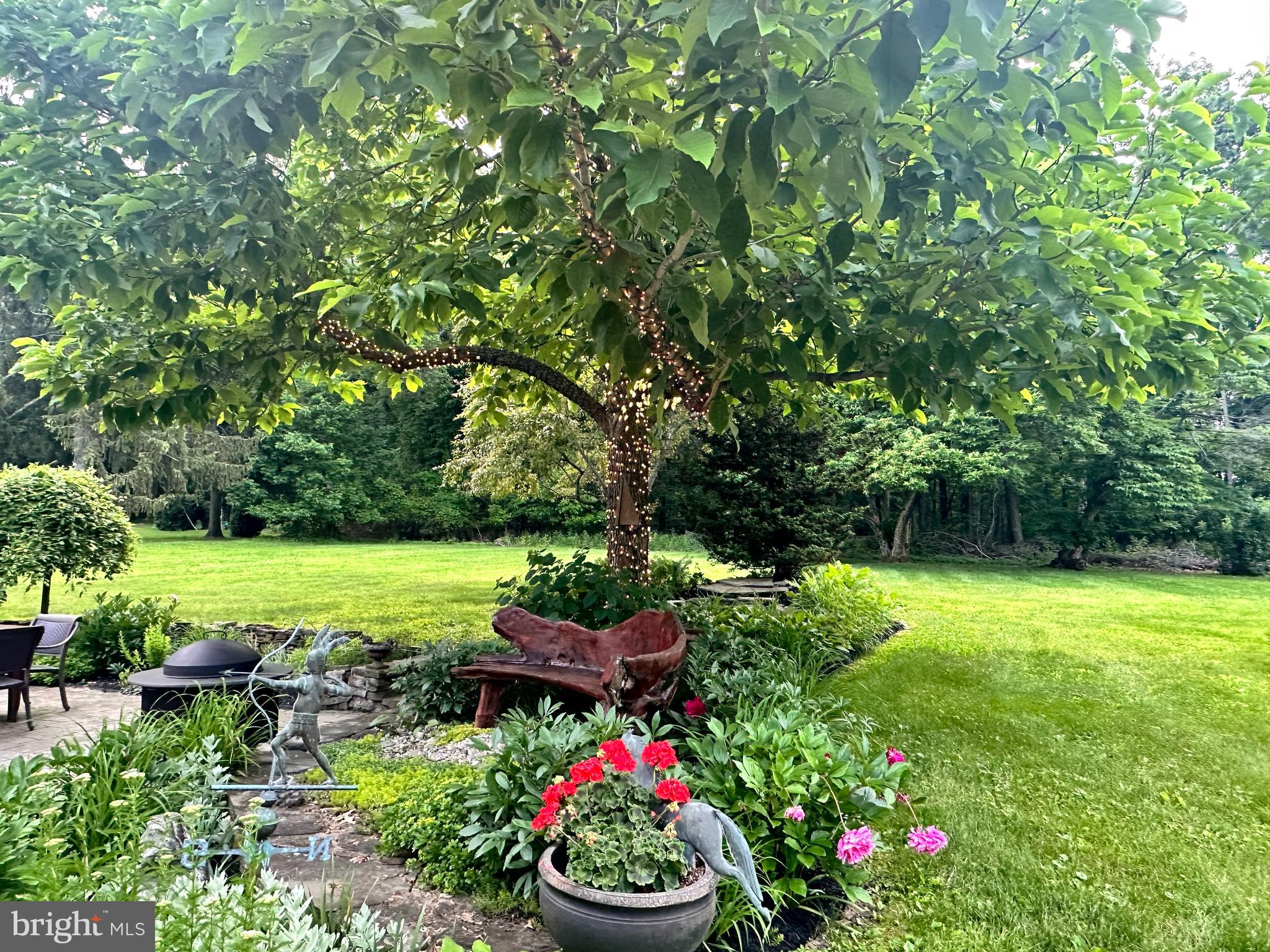 4367 Curly Hill Road Doylestown, PA 18902 - Photo 72 of 72 a view of a backyard with plants and a fountain