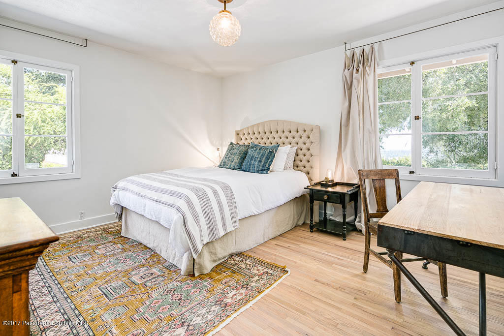 1336 Inverness Drive Pasadena, CA 91103 - Photo 21 of 42 a bedroom with a bed a table and a large window