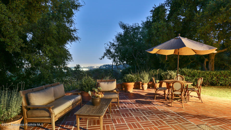 1336 Inverness Drive Pasadena, CA 91103 - Photo 38 of 42 a view of a patio with a table and chairs under an umbrella with a barbeque grill and plants