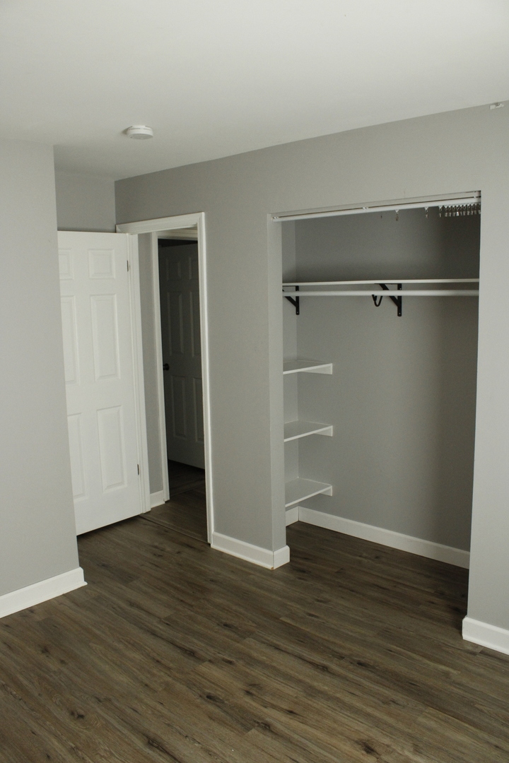 366 Cedarbrook Road Naperville, IL 60565 - Photo 11 of 20 an empty room with wooden floor and closet