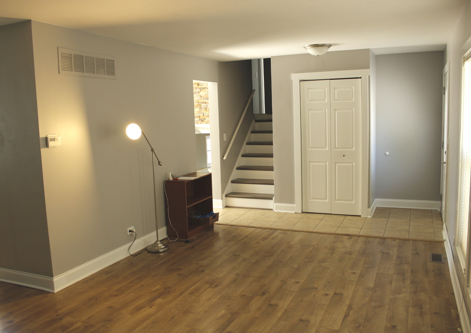 366 Cedarbrook Road Naperville, IL 60565 - Photo 3 of 20 an empty room with wooden floor and windows