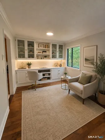 a living room with furniture stove and large window