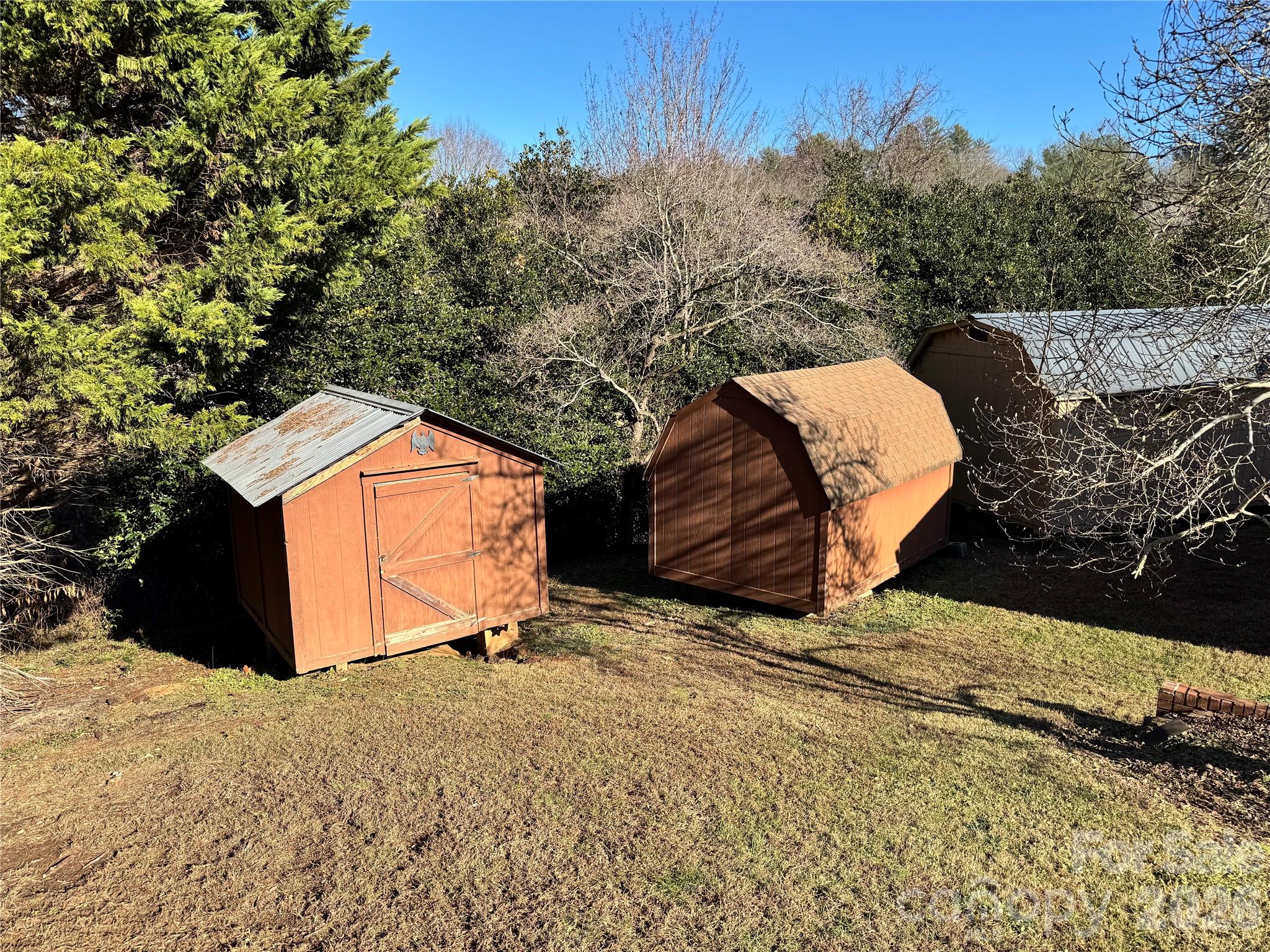 2448 Christopher Road Morganton, NC 28655 - Photo 19 of 32 a backyard of a house with a yard and garage