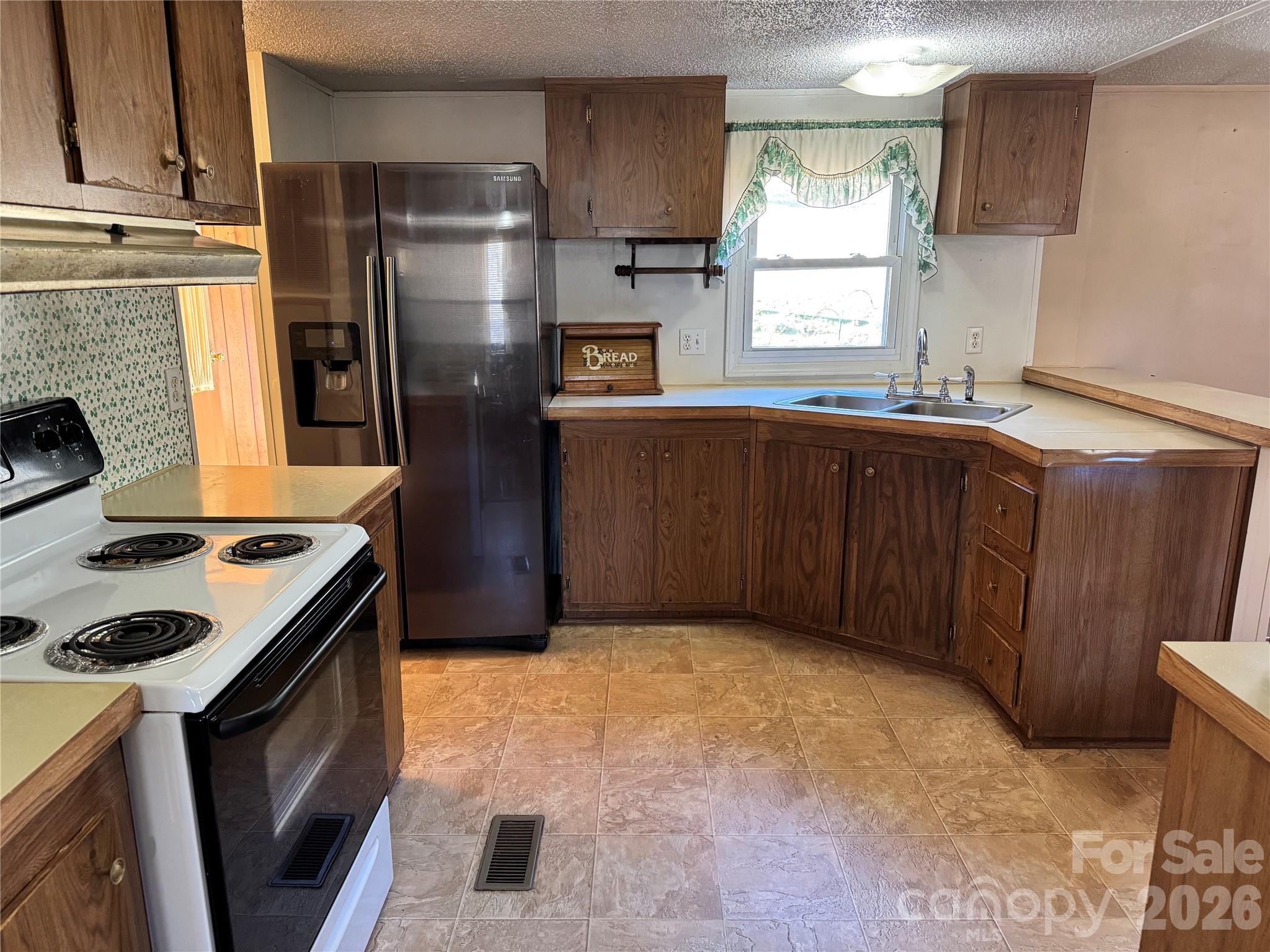 2448 Christopher Road Morganton, NC 28655 - Photo 7 of 32 a kitchen with stainless steel appliances granite countertop a refrigerator a stove a sink and a microwave