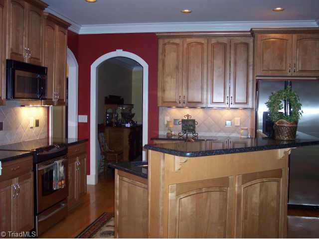 8211 Kelly Ford Road Oak Ridge, NC 27310 - Photo 4 of 9 Other. Cooks delight Kitchen with ginger glazed maple cabinets, granite, tile backspash, accent lighting, s/s applianced including convection oven and open to breakfast room and greatroom. Makes entertaining easy.