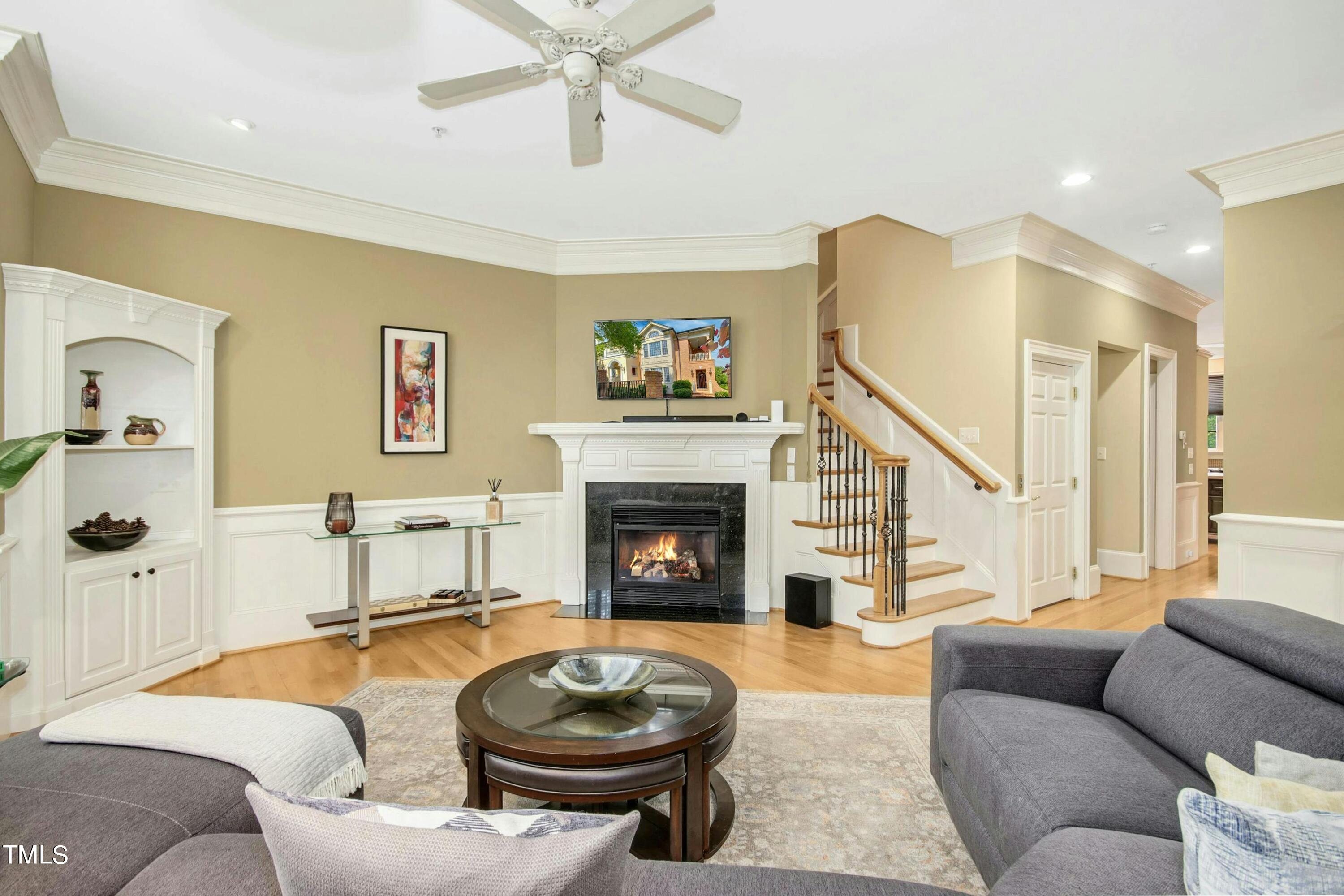 212 West Barbee Chapel Road Chapel Hill, NC 27517 - Photo 17 of 75 a living room with furniture a fireplace and a flat screen tv
