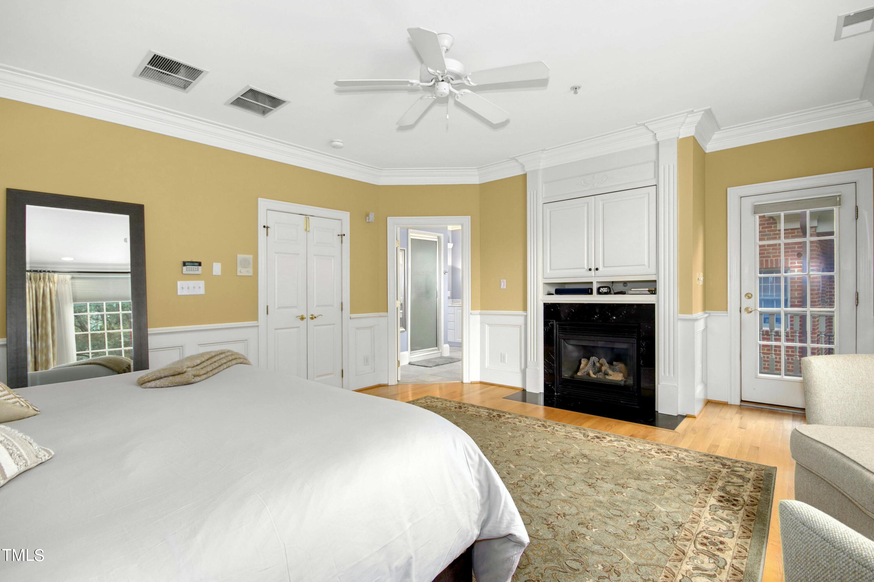 212 West Barbee Chapel Road Chapel Hill, NC 27517 - Photo 39 of 75 a spacious bedroom with a bed and a fireplace