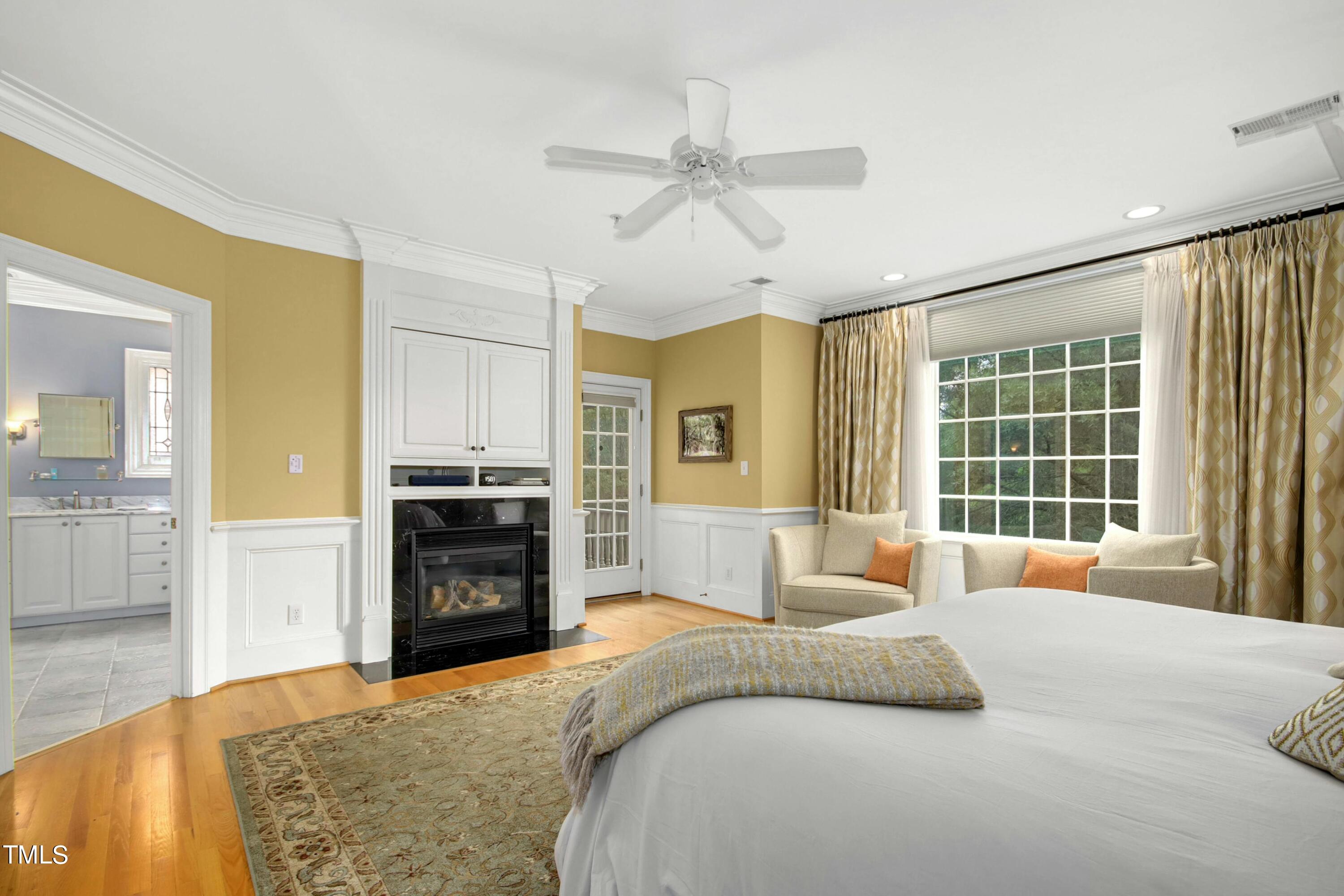 212 West Barbee Chapel Road Chapel Hill, NC 27517 - Photo 40 of 75 a large bedroom with a bed and wooden floor