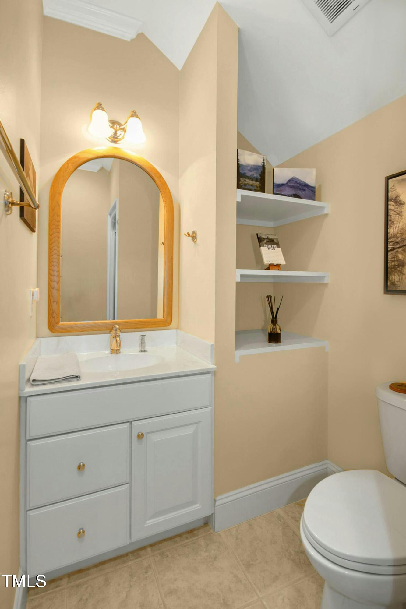 212 West Barbee Chapel Road Chapel Hill, NC 27517 - Photo 56 of 75 a bathroom with a toilet a sink and mirror