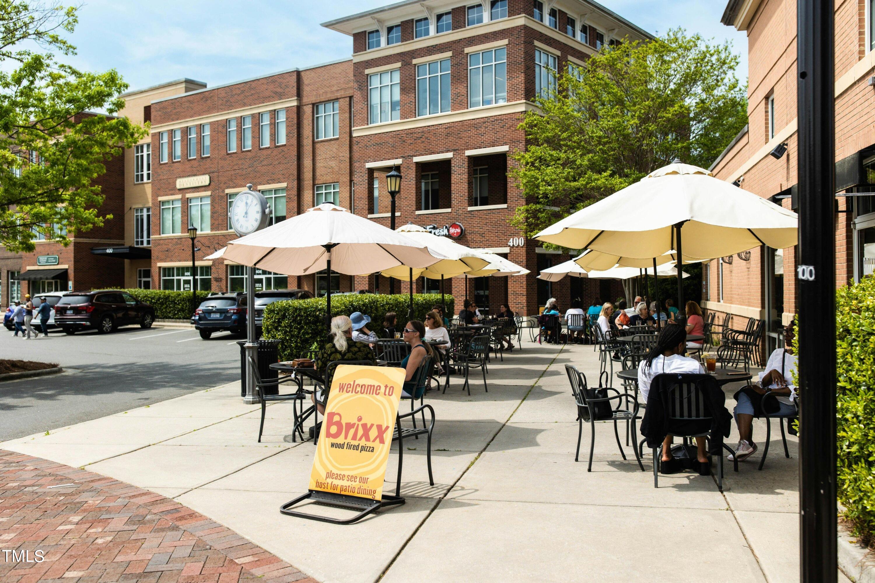 212 West Barbee Chapel Road Chapel Hill, NC 27517 - Photo 65 of 75 a view of a patio with a table and chairs under an umbrella