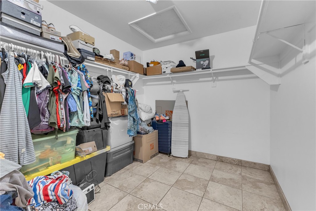 48734 Chichen Itza Road Coachella, CA 92236 - Photo 11 of 18 a view of walk in closet with clothes and shoes