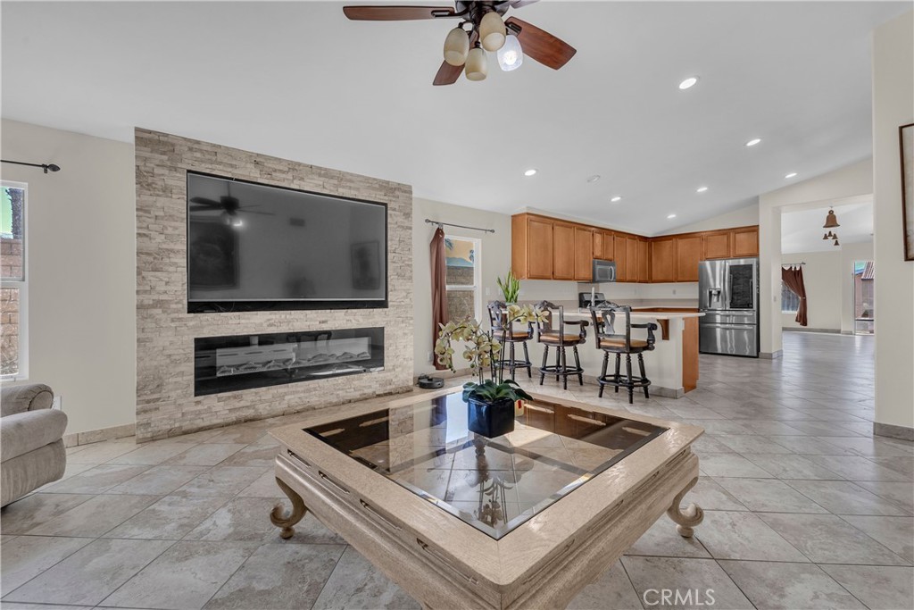 48734 Chichen Itza Road Coachella, CA 92236 - Photo 2 of 18 a kitchen with stainless steel appliances a dining table a stove a microwave a dining table and chairs with wooden floor